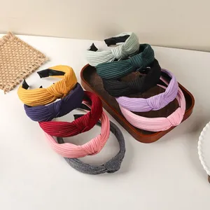 Close up detail of assorted fabric knotted headbands in multiple vibrant and neutral colors.