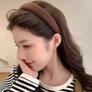 Brown velvet padded headband detail shot, stylish high skull design hair accessory for women.