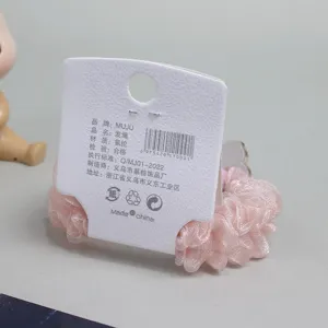 Pink mesh hair scrunchie detail view, elegant elastic hair band with product card tag.