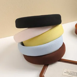 Detailed close-up of thick sponge padded hair hoops in multi-colors, soft and stylish design.