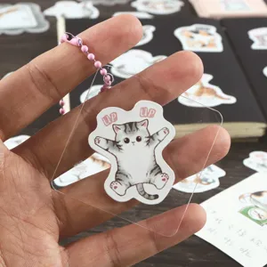Cute transparent acrylic cat keychain charm with bead chain, adorable cartoon kitten pendant.
