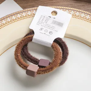 2pcs brown fuzzy hair ties with square charms, soft plush hair accessories for daily wear.