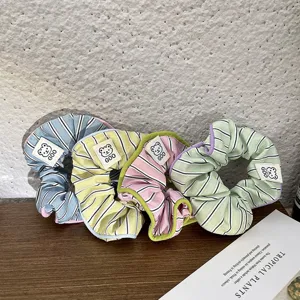 Sweet cream striped hair scrunchies detail view, cute bear label cute ponytail hair rope.