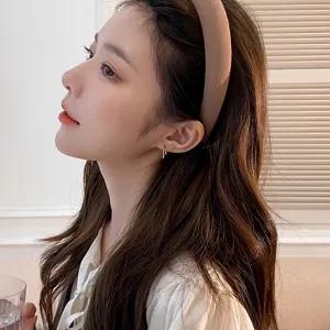Detail shot of a chic beige wide sponge headband, perfect for daily makeup and face washing.