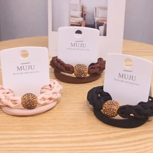 Detailed shot of Korean style hair ties with sparkling rhinestone balls and braided bands.