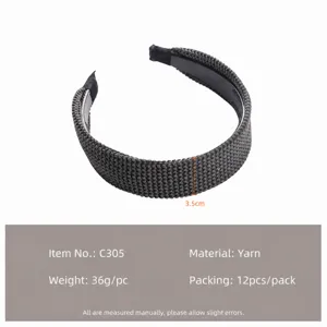 Detailed view of the dark grey knitted hair hoop, featuring soft wool material and wide design.