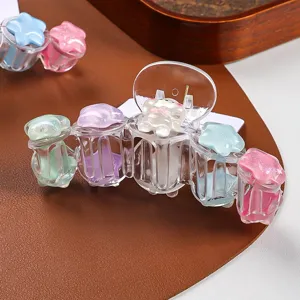 Cute colorful star hair claw detail showing transparent acrylic design and sweet cartoon charm.