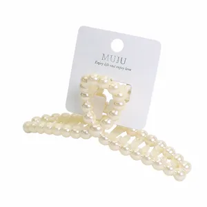 Sweet imitation pearl hair claw clip with display card, elegant lazy hair styling accessory.
