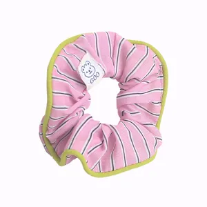 Sweet pink striped hair scrunchie with green trim and cute bear tag for daily wear.