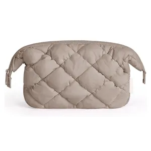 Quilted puffer cosmetic bag detail, soft cloud pouch zipper closure, travel makeup organizer.