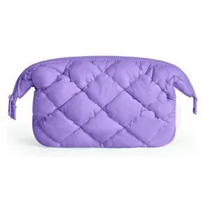 Close-up of a purple quilted puffy cosmetic bag detail showing soft texture and zipper.