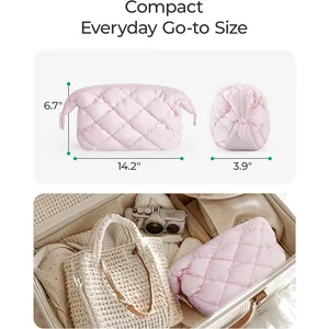 Quilted makeup bag detail view showing compact size, spacious capacity and pink color.