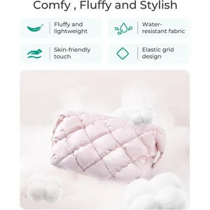 Pink quilted cosmetic bag with puffy cloud design, lightweight and water-resistant for travel.