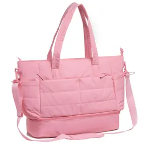 Pink travel duffel bag detail, large capacity gym bag with bottom compartment and shoulder strap.