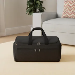 Detail shot of black travel garment duffel bag showing zippers and durable fabric texture.