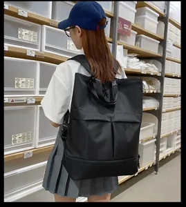 Grand sac à dos noir pour hommes et femmes, cartable de loisirs multifonctionnel.