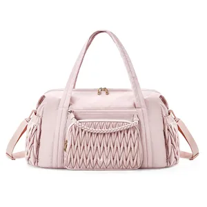 Pink quilted travel duffel bag with stylish braided front pocket detail for women fitness workout.
