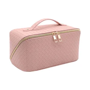 Pink woven cosmetic bag with gold zipper, large capacity portable makeup organizer case.