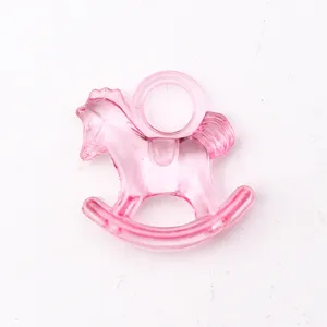 Close-up detail of a translucent pink acrylic rocking horse charm with top hanging loop.