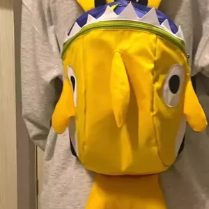 Cute yellow shark kids backpack with 3D fins and teeth, perfect for toddler boys.