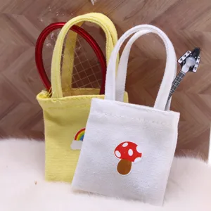 Miniature canvas tote bag detail shot for dollhouse, featuring cute mushroom and rainbow designs.