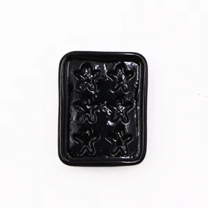 1:12 dollhouse miniature black baking tray with gingerbread man shapes detail view close up