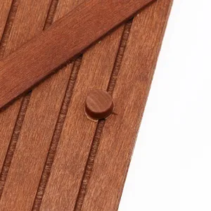 Miniature wooden dollhouse door detail part with vertical slats and diagonal cross brace design.