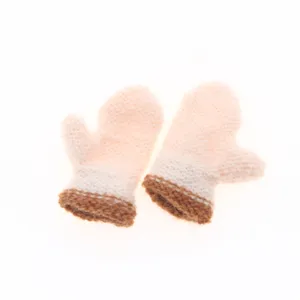 Close-up detail of miniature knitted wool mittens in pink and brown, cute accessory.