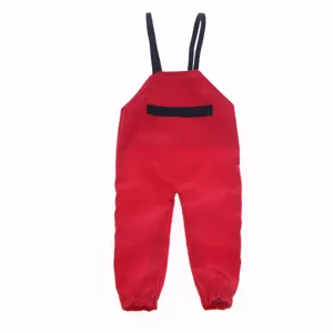 Miniature red doll bib pants detail, cute BJD dollhouse clothing accessory for outdoor scene.