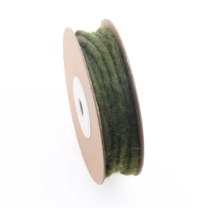 Handmade wool felt rope spool in dark green, perfect for DIY crafts and holiday decor.
