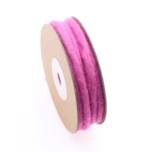 Close-up detail of magenta wool felt cord wrapped on spool, ideal for DIY crafts and decor.