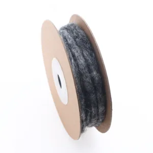Detail view of dark grey wool felt cord wound on a cardboard spool for crafting projects.