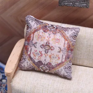 Miniature dollhouse bohemian style throw pillow, delicate vintage pattern mini sofa cushion detail.