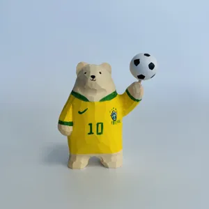 Wooden bear sculpture detail showing the Brazil number 10 jersey and hand-held soccer ball.