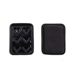 Detailed view of miniature black heart baking tray for 1:12 scale dollhouse scene.