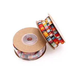 Close-up detail of colorful ethnic style cord wrapped on cardboard spools for crafting.