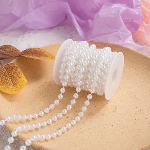 White plastic pearl bead string detail view, perfect for wedding and Christmas decoration.