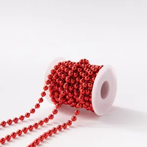 Red plastic bead chain spool on white reel for Christmas tree DIY wedding decoration