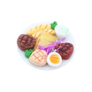 Miniature food model detail showing a tiny steak, bread, and egg plate for dollhouse decor.
