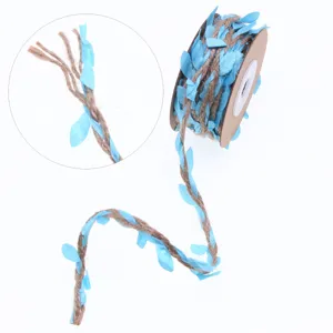 Detailed close-up of blue fabric leaves woven with natural jute twine for creative crafts.