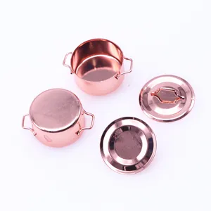 Miniature metal soup pot detail, rose gold dollhouse kitchen accessory, close-up view.