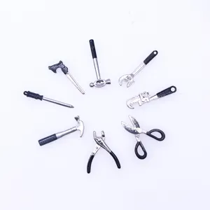 Detailed view of miniature metal alloy repair tool set, perfect for dollhouse scenes.