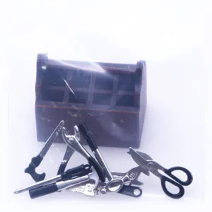 Miniature dollhouse tool set with metal mini tools and wooden box for micro scenes.