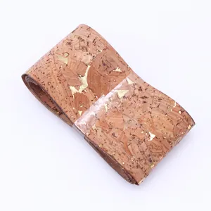 Close-up view of the natural cork ribbon with gold foil flakes, showing texture and detail.