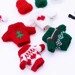 Close-up detail of mini doll knitted sweater set, festive Christmas patterns and cute styles.
