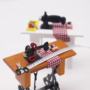 Miniature dollhouse sewing machine and tape measure set dollhouse miniature accessories detail view.