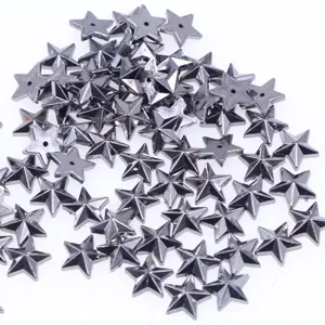 Detailed close-up shot of scattered dark metallic star-shaped beads for DIY craft accessories.
