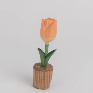Wooden tulip flower sculpture detail showing fine carving and natural wood grain texture.