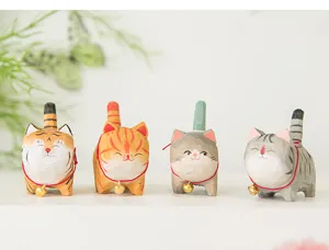 Hand-carved wooden cat figurines set, cute desktop ornaments with bells for home decor.