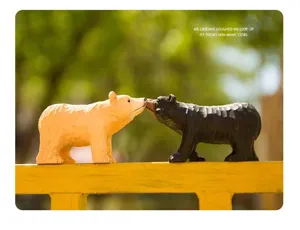 Handmade wooden bear figurines kissing detail, charming rustic home decor ornament piece.